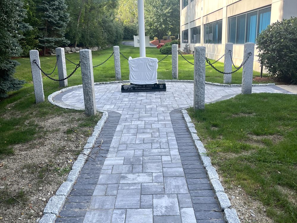 Paver walkway with a contrasting border running through a lawn